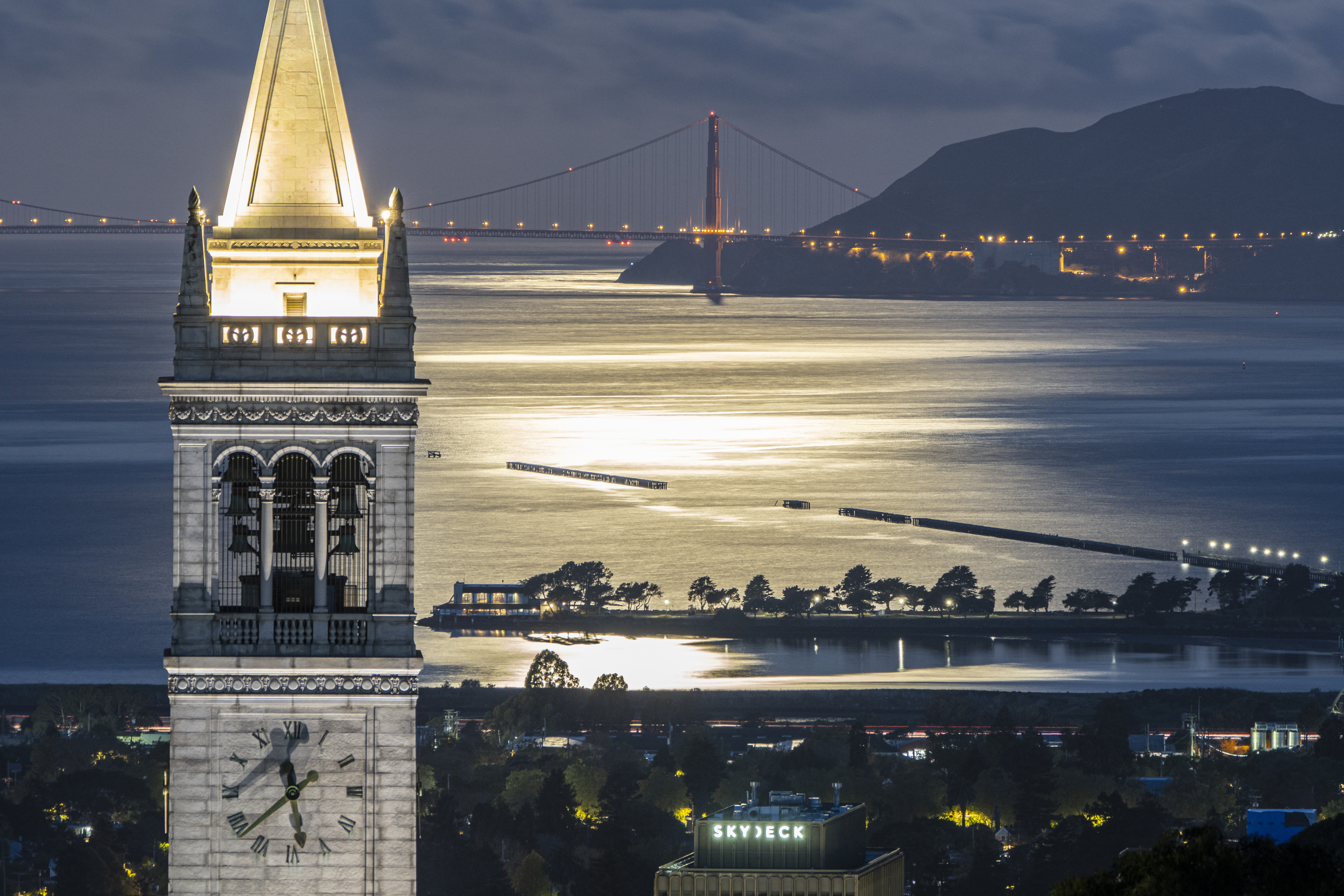 Photo of campanile at night with bridge behind