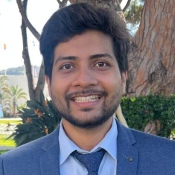Headshot in a blue suit and tie