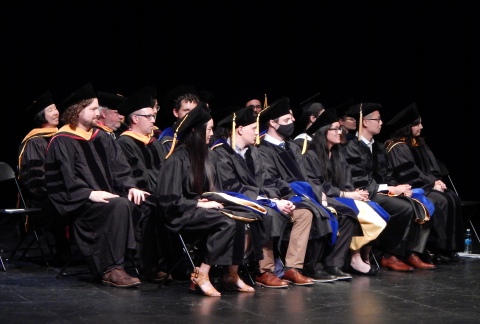 faculty and PhD students on stage 